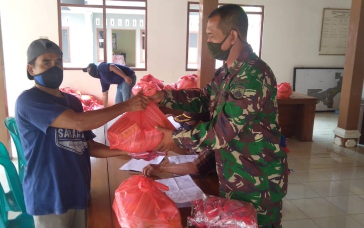 Babinsa setempat membantu pemberian sembako bagi warga Purworejo