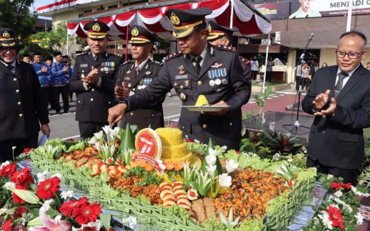 Kapolrestabes Medan Kombes Valentino Alfa Tatareda saat memotong tumpeng HUT Bhayangkara ke 77