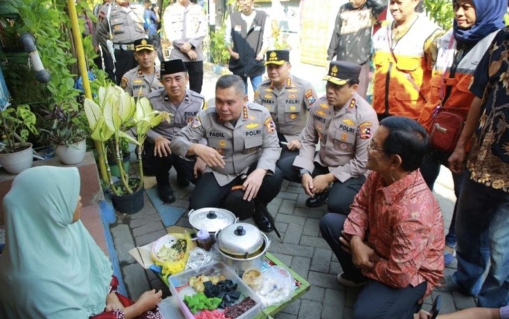 Kapolda Jatim Irjen Pol Toni Harmanto saat mendampingi Kabaharkam Polri Komjen Fadil Imran berdialog dengan penjual makanan di Surabaya, Kamis (27/7)