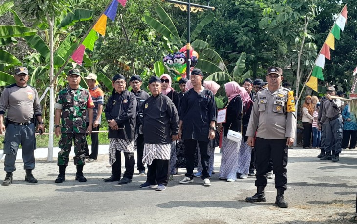 Babinsa Desa Sirapan Memantau Kegiatan Kirab Tumpeng dalam Rangka Bersih Desa Ke-197