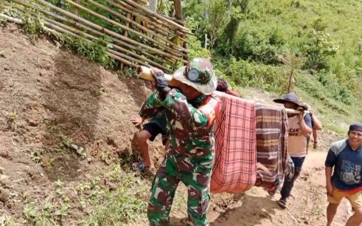  Serda Suryanto Babinsa Desa Ulumanda Koramil 1401-04/Malunda membantu proses evakuasi dengan tandu (sebatang bambu dan kain sarung) salah seorang warga di wilayah binaannya guna mendapatkan perawatan medis yang lokasinya berada di wilayah terpencil, Dusun Tamajannang, Desa Ulumanda, Kab. Majene, Sulawesi Barat, Minggu (14/1/2024)