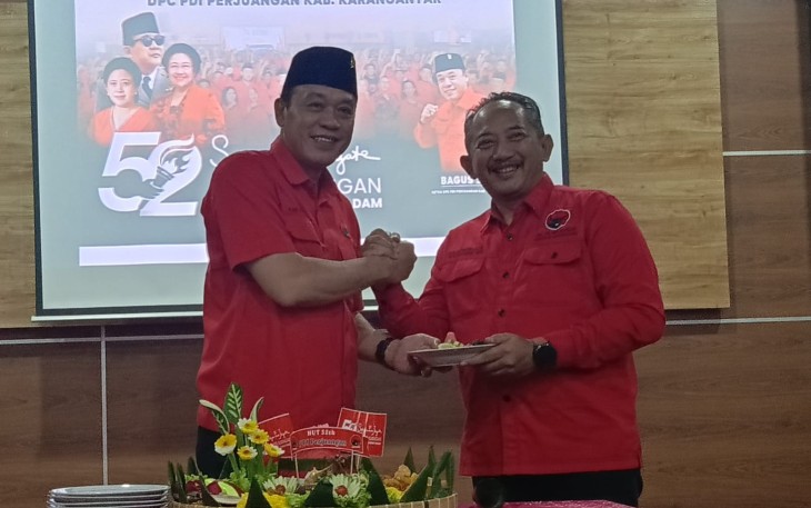 Ketua DPC PDIP Karanganyar Bagus Selo menyerahkan potongan tumpeng kepada Rober Christanto saat perayaan HUT PDIP ke-52, di Kantor DPC PDIP Karanganyar, Jumat (10/1/2024).