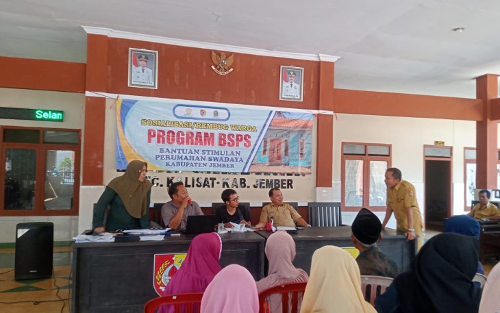 Kepala Desa Gambiran, Rahmat Hidayat, berdiskusi dengan TFL BSPS saat rembug warga penetapan 19 calon penerima bantuan bedah rumah Program BSPS 2026 di Balai Desa Gambiran, Kecamatan Kalisat, Kabupaten Jember, Senin (11/5/2026).