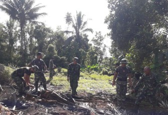 Personil kodim 1310/Bitung sedang mempersiapkan lahan untuk tanam jagung.