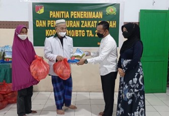 Dandim 1310/Bitung didampingi ketua persit, saat pembagian zakat fitrah, Jumat (29/4/2022)