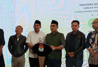 Komisioner KPU Jatim Choirul Umam saat menggelar press conferen di Data Center KPU Jatim di Double Tree Hotel Surabaya, Kamis (28/11/2024) malam