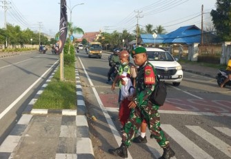 Peduli Keselamatan Anak Sekolah, Secara Rutin Babinsa Koramil Jajaran Kodim 1710/Mimika Bantu Seberangkan Jalan