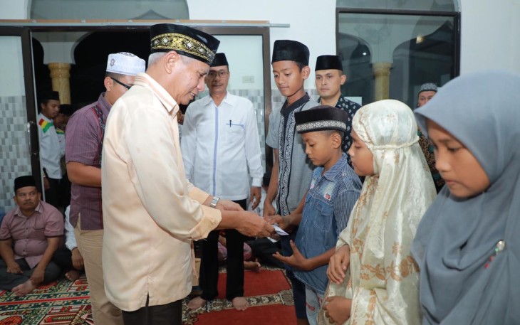 Plt. Bupati Asahan, Surya saat menyerahkan bantuan kepada anak yatim di Mesjid Nurul Hasanah