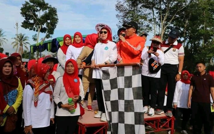 Bupati Lambar Bersama ketua PKK Lambar Partinia Parosil mengibarkan bendera tandanya di mulai jalan sehat