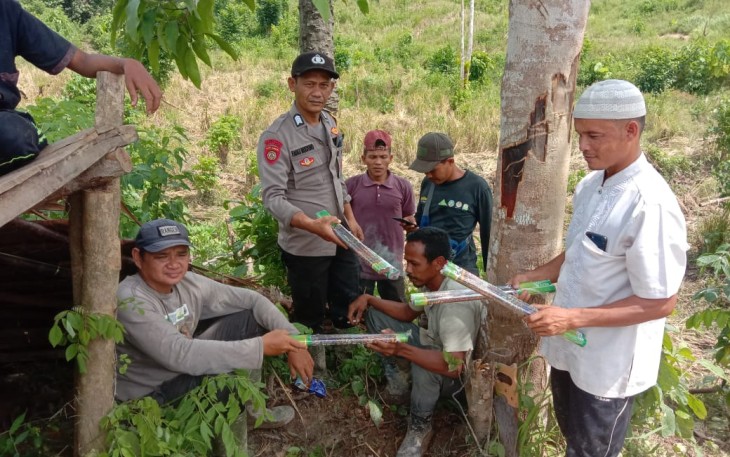 Bhabinkamtibmas Polsek Ranto Peureulak Bripka Fadli Mulyono bersama warga Desa Seumanah Jaya saat melakukan penanganan gangguan gajah liar.