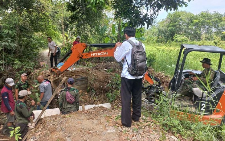 Babinsa Koramil 07/Amuntai Tengah Kodim 1001/HSU-Balangan membantu warga binaan yang sedang melakukan pembangunan jembatan.