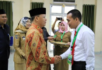 Pengalungan tanda peserta oleh Plt. Gubernur Bengkulu Rohidin Mersyah.
