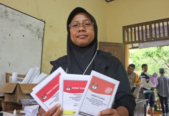 Ernita Oktaviani selaku Ketua KPPS TPS 14, Desa Wonorejo, Kecamatan Karanganyar, Kabupaten Demak menunjukkan surat suara, pada Pemilu susulan, Sabtu (24/2).